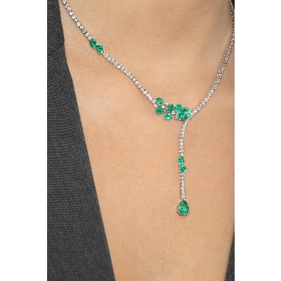 Fancy tennis necklace with emeralds and diamonds