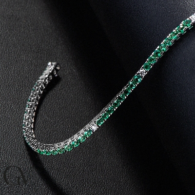 Square links tennis bracelet with emeralds and round cut diamonds