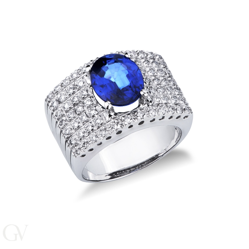 Band ring with a central blue sapphire oval cut and diamonds