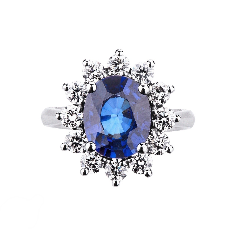 White gold 18k ring with twelve halo diamonds and a central blue sapphire