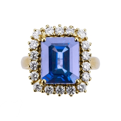 Halo ring with blue sapphire and diamonds in yellow gold 18k