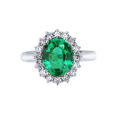 Halo ring with oval cut central emerald and diamonds in white gold 18k