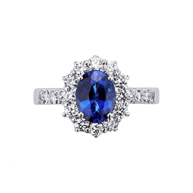 White gold 18k halo ring with blue sapphire and diamond shoulder set 