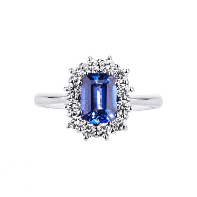 White gold 18k halo ring with diamonds and a central blue sapphire 