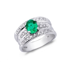 Band ring with a central emerald and diamonds in white gold 18k