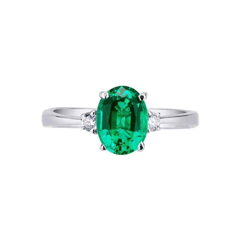 White gold 18k ring with emerald and one diamond on each side