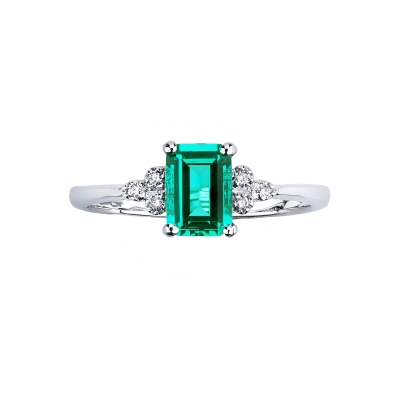 White gold 18k ring with an emerald and three bezel diamonds 