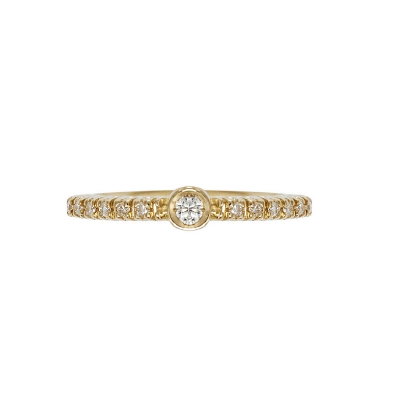 Yellow gold 18k ring with central bezel diamond and diamonds shoulder set 