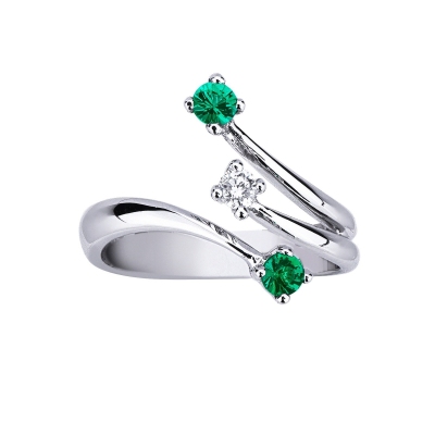 18k white gold trilogy engagement ring with 2 emeralds and a diamond
