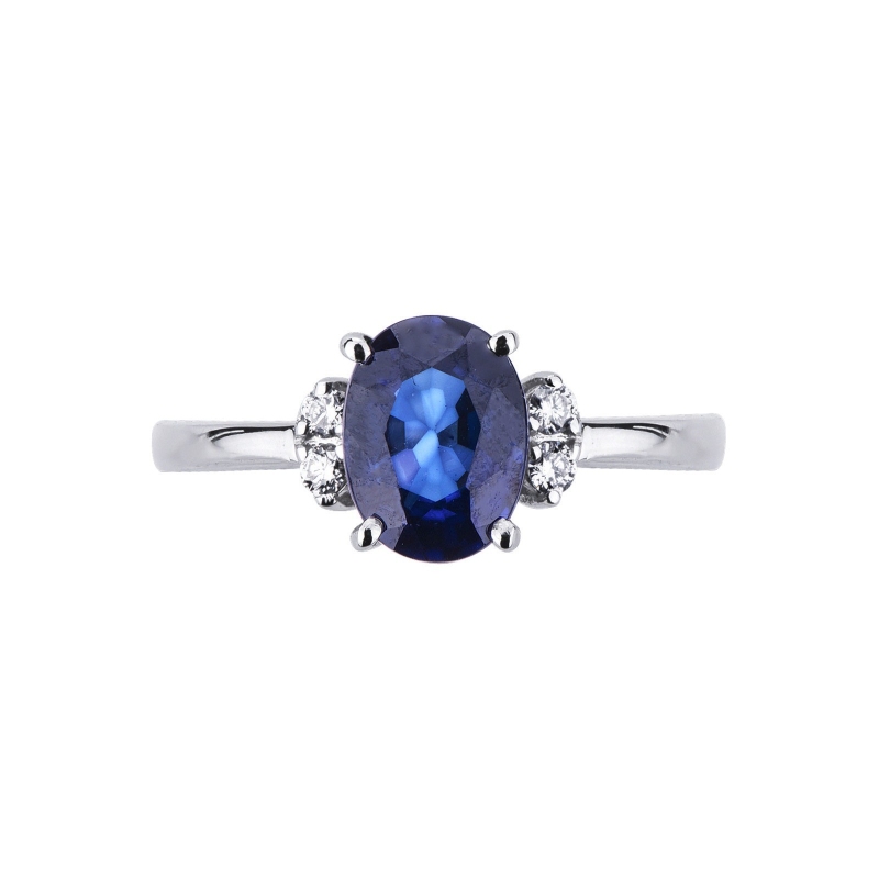 18k white gold ring with a blue sapphire and two diamonds each side