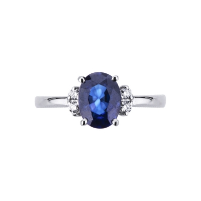 18k white gold ring with a blue sapphire and two diamonds each side
