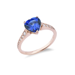 Rosé gold 18k ring with blue sapphire and diamond shoulder set 