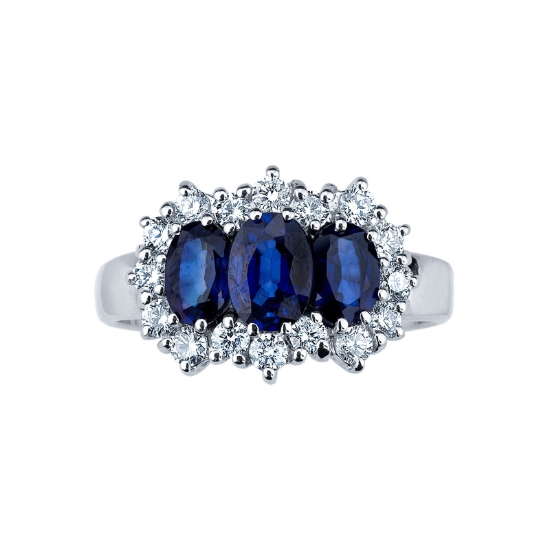 Trilogy type ring with central blue sapphires and halo diamonds 