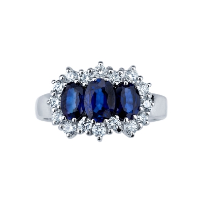 Trilogy type ring with central blue sapphires and halo diamonds 