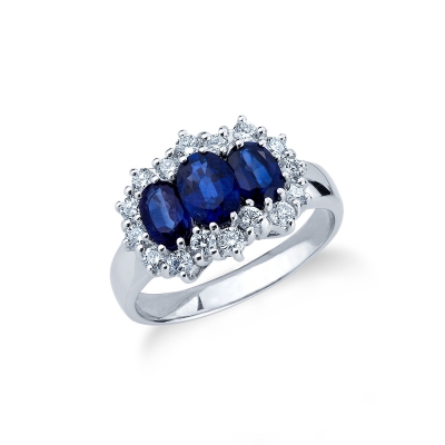 Trilogy type ring with central blue sapphires and halo diamonds 