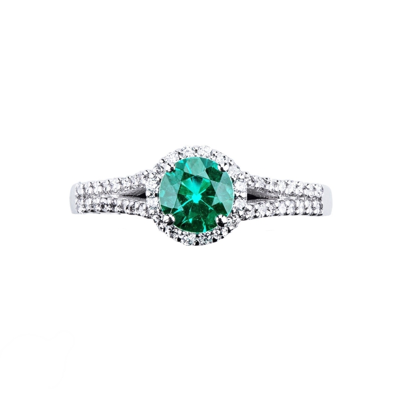 Solitaire type ring with a central emerald and diamonds shoulder set 