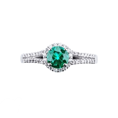 Solitaire type ring with a central emerald and diamonds shoulder set 
