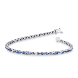 Tennis bracelet with blue sapphires and round cut diamonds in 18k white gold