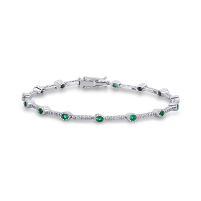 Segment bracelet with emeralds and round cut diamonds