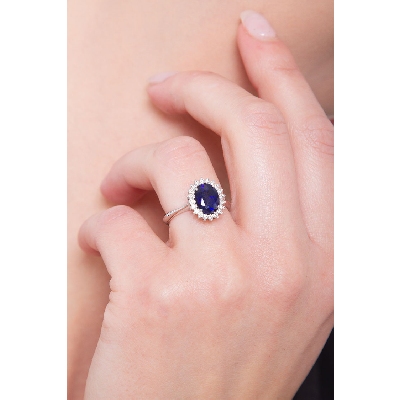 Halo ring with diamonds and blue sapphire oval cut white gold 18k