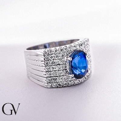 Band ring with a central blue sapphire oval cut and diamonds