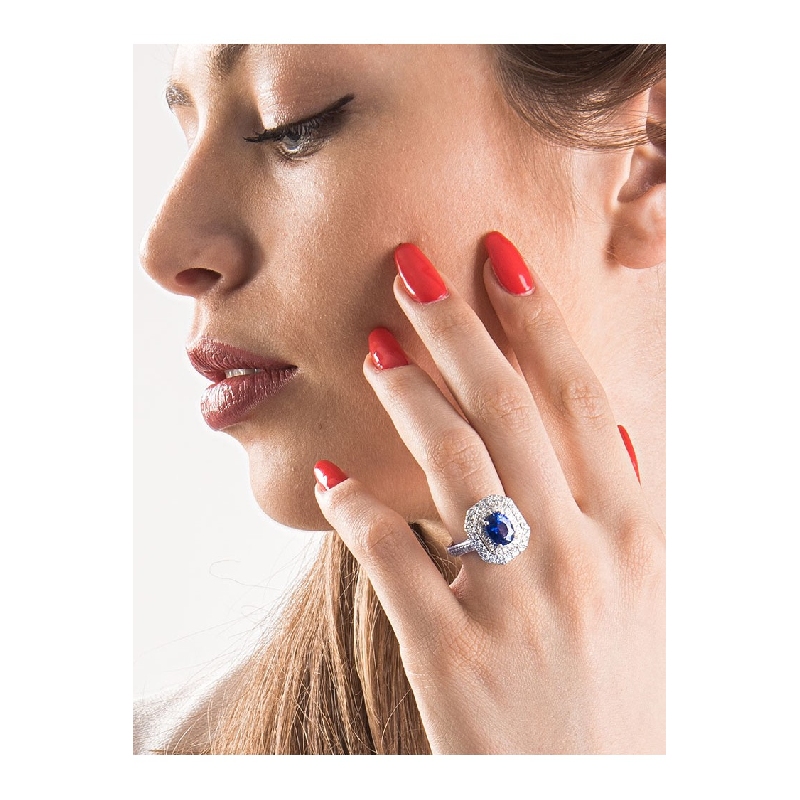 Halo ring with a central blue sapphire and diamonds white gold 18k