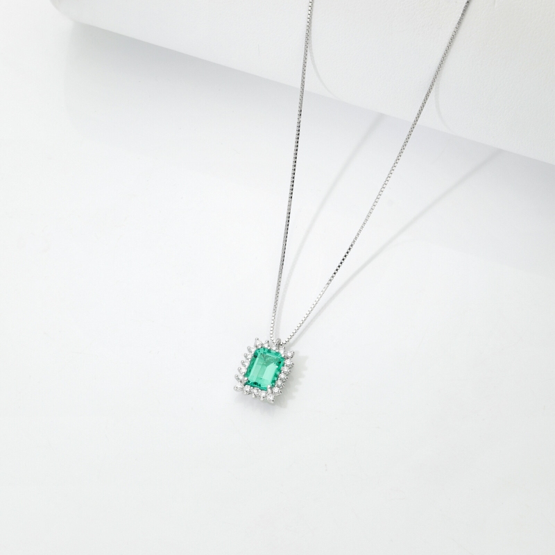Necklace with pendant, emerald and round cut diamonds
