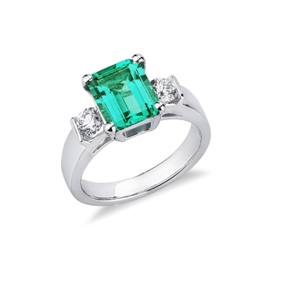 18k white gold ring with a central emerald and side diamonds 
