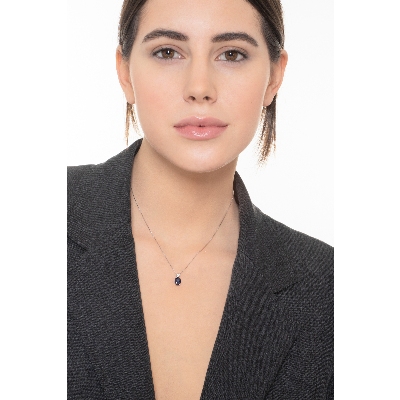 Blue sapphire pendant with round cut diamond