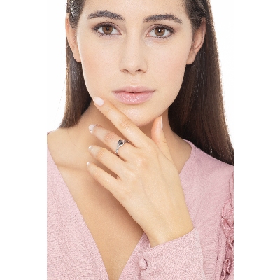 Solitaire type ring with black central diamond and halo and shoulder set diamonds 