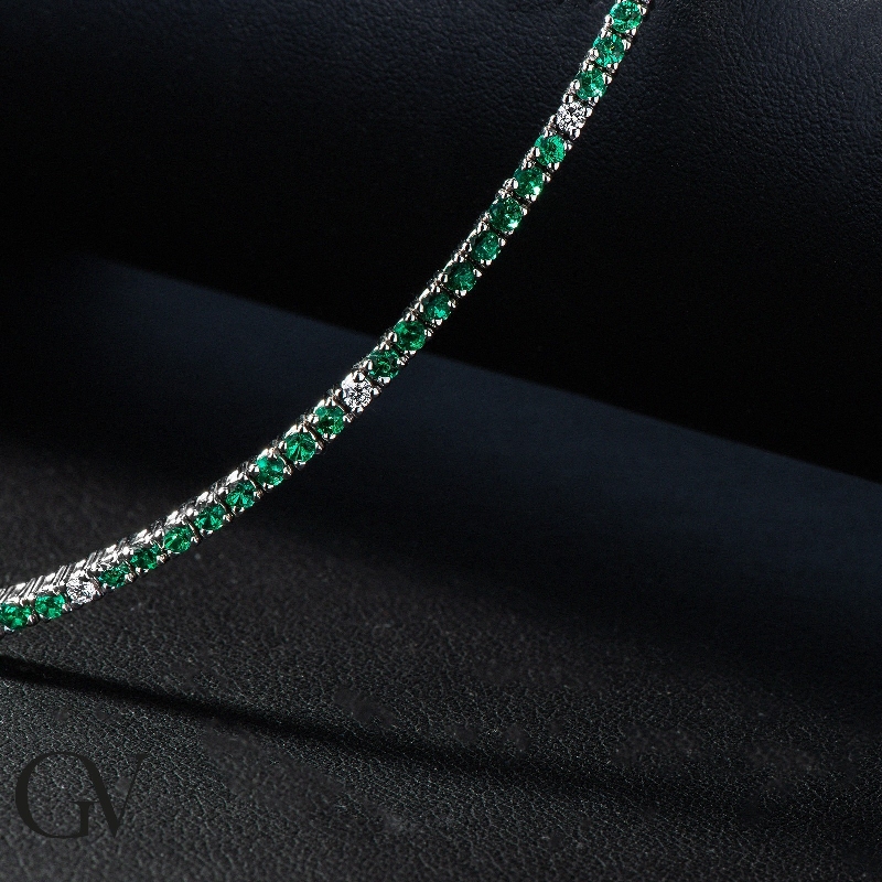 Wire style tennis bracelet with emeralds and diamonds