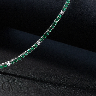 Wire style tennis bracelet with emeralds and diamonds