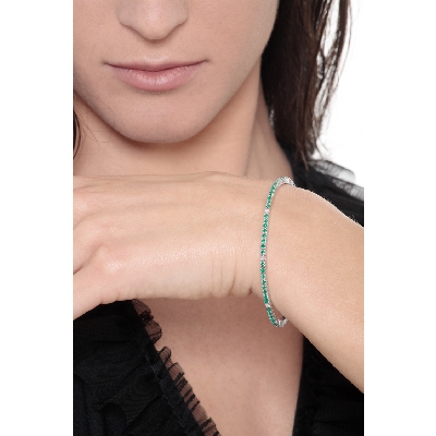 Wire style tennis bracelet with emeralds and diamonds