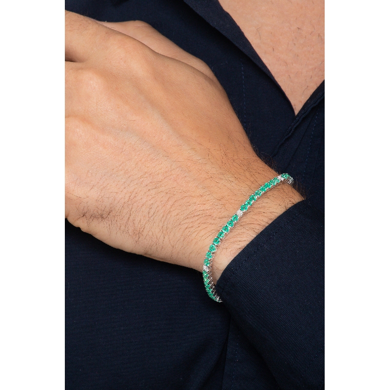 18k white gold tennis bracelet with emeralds and round cut diamonds